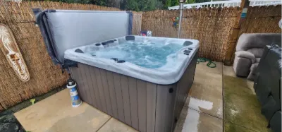 Hot tub set into a fenced patio