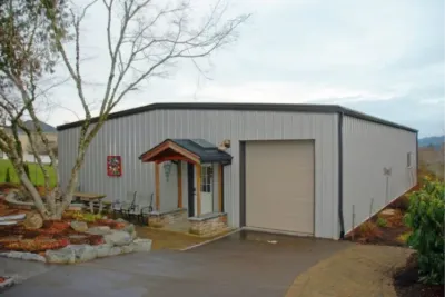 Light gray steel building with an entry porch
