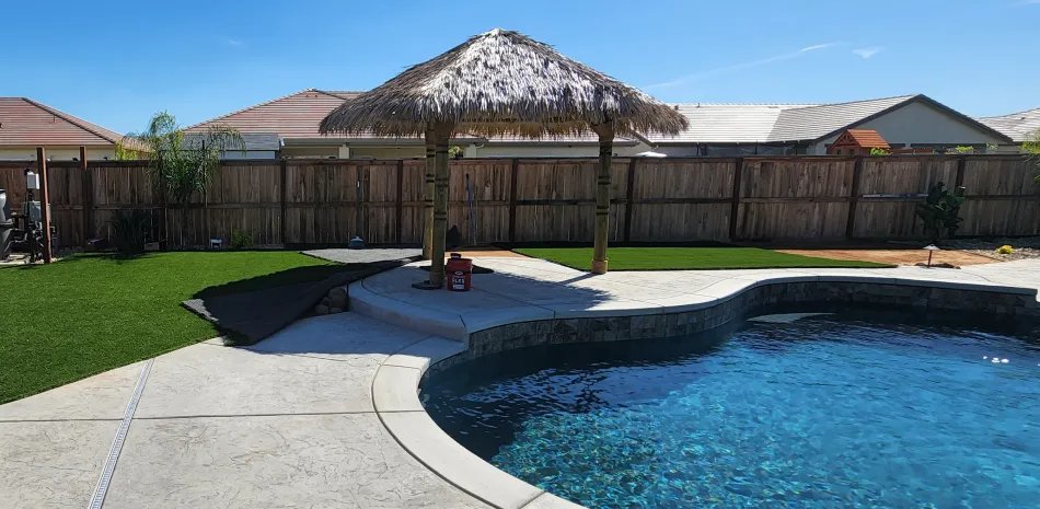 Thatched palapa shading a patio beside a blue pool in Citrus Heights, CA