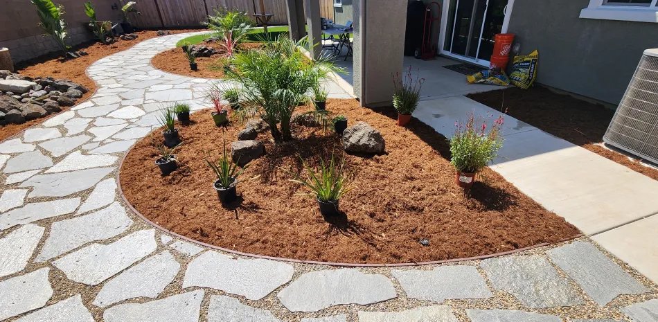 Flagstone path with fresh mulch beds and drought-tolerant plants in Placerville, CA